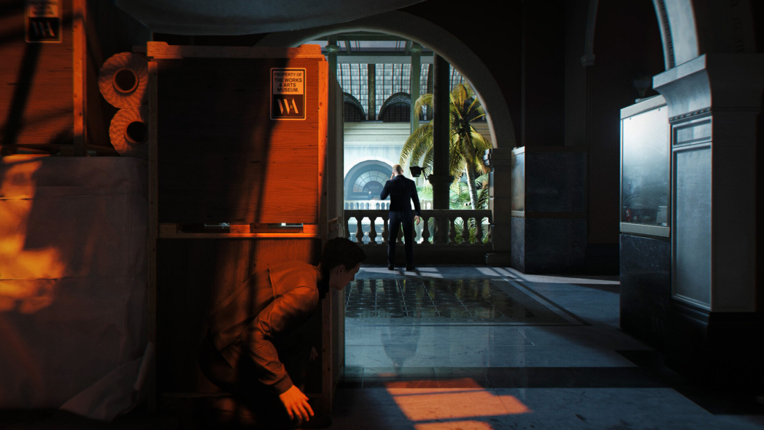 Person in dark clothing sneaking in a shadowy corridor with another person standing on a balcony overlooking a palm-lined avenue in the background