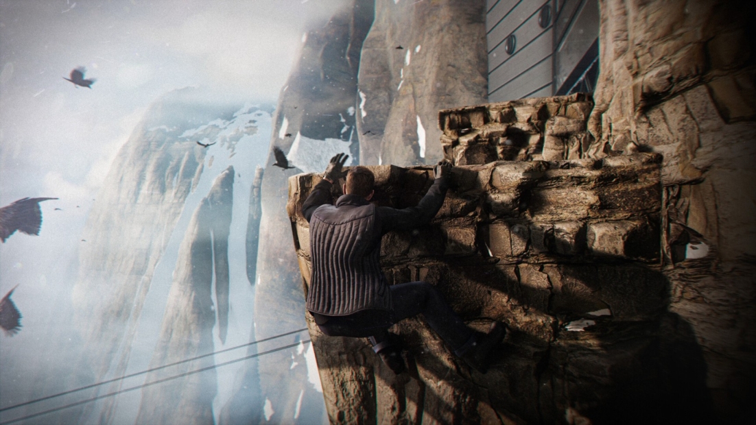 Two people climbing a rocky cliff in a mountainous landscape with mist and birds in the background
