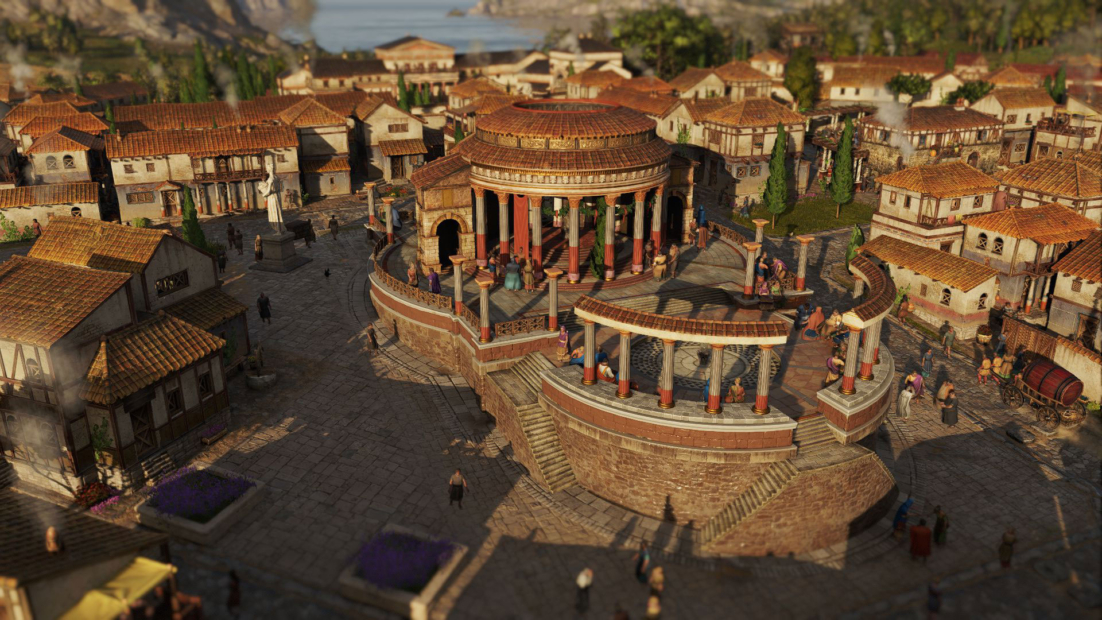 Römischer Tempel mit rundem Grundriss und Säulengang, umgeben von Häusern mit roten Ziegeldächern.