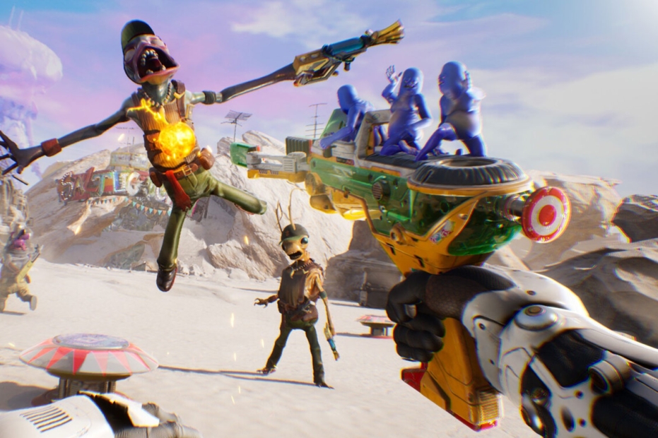 Scene from a video game showing a futuristic weapon held by a robotic hand and two humanoid figures in a desert landscape