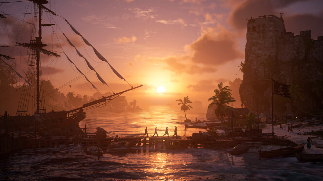 Sailing ship docked at shore at sunset with four people walking on a pier and an old fortress in the background