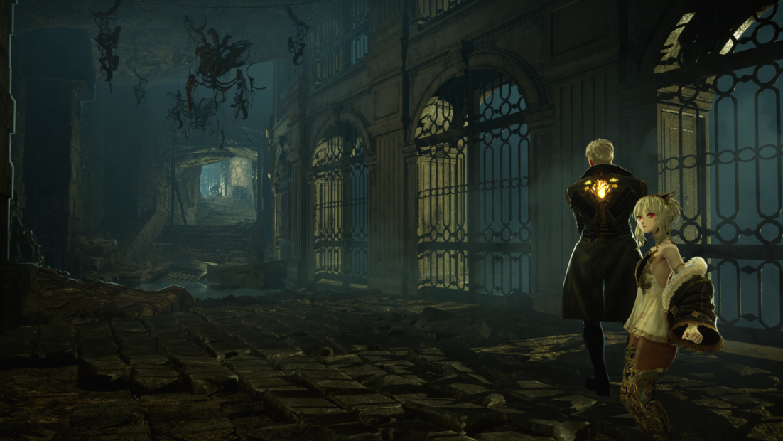 Two people in a dark, ruined hall with large windows and broken floor, one wearing a long coat with a glowing pattern on the back