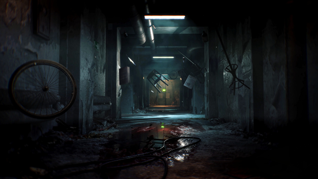 Dark, abandoned corridor with wet floor, a bicycle, a chair, and various objects hanging on the walls.