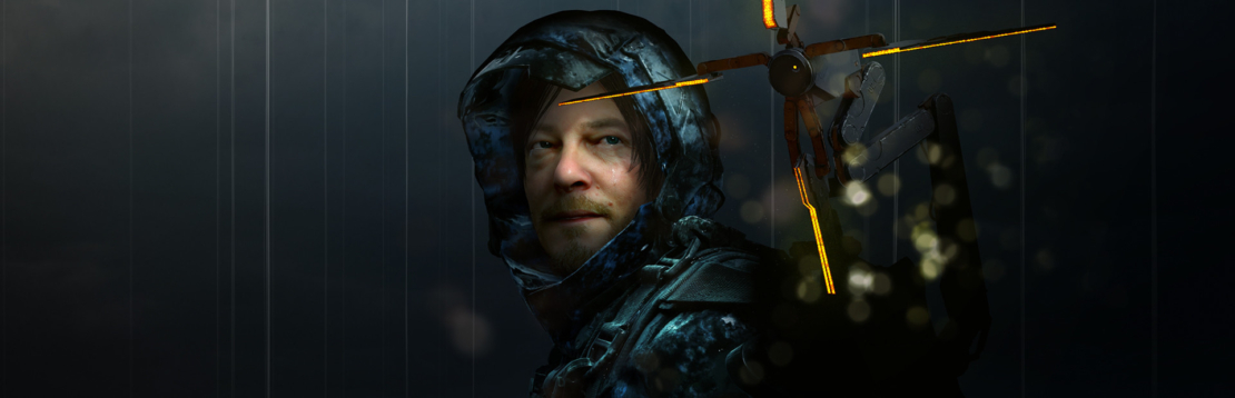 Close-up of a man in dark, wet protective clothing holding a glowing mechanical device on his hand