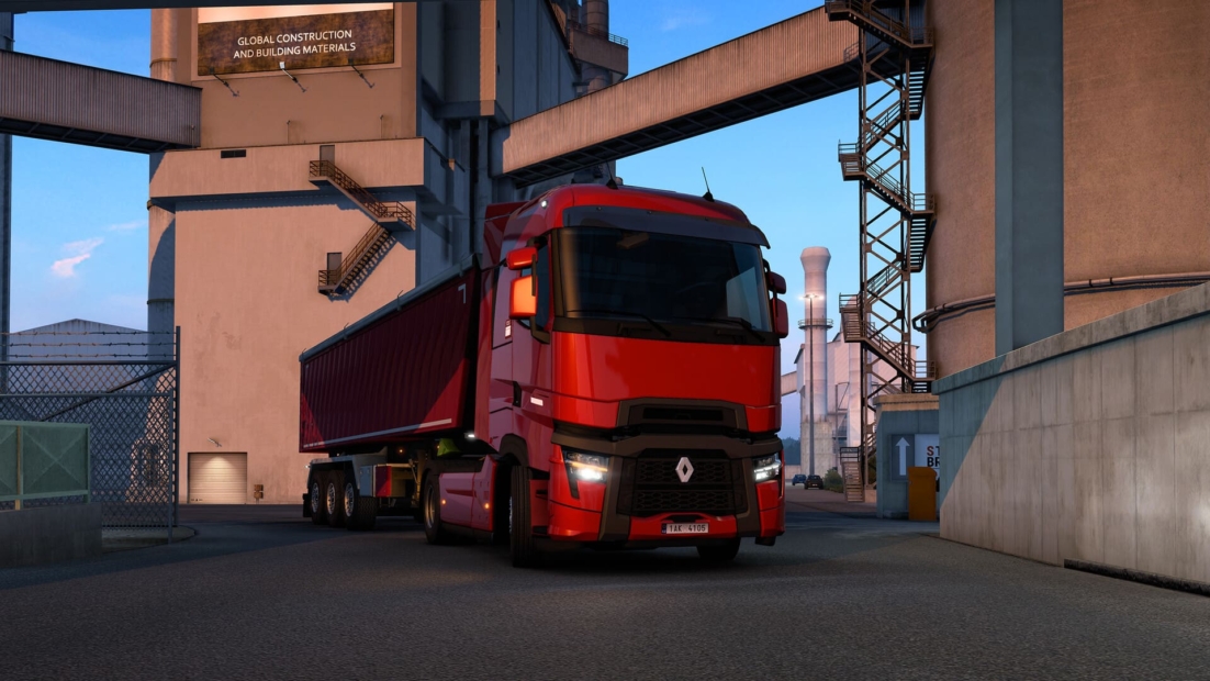 Red Renault semi-truck with trailer parked near industrial buildings labeled 'Global Construction and Building Materials' in Euro Truck Simulator 2