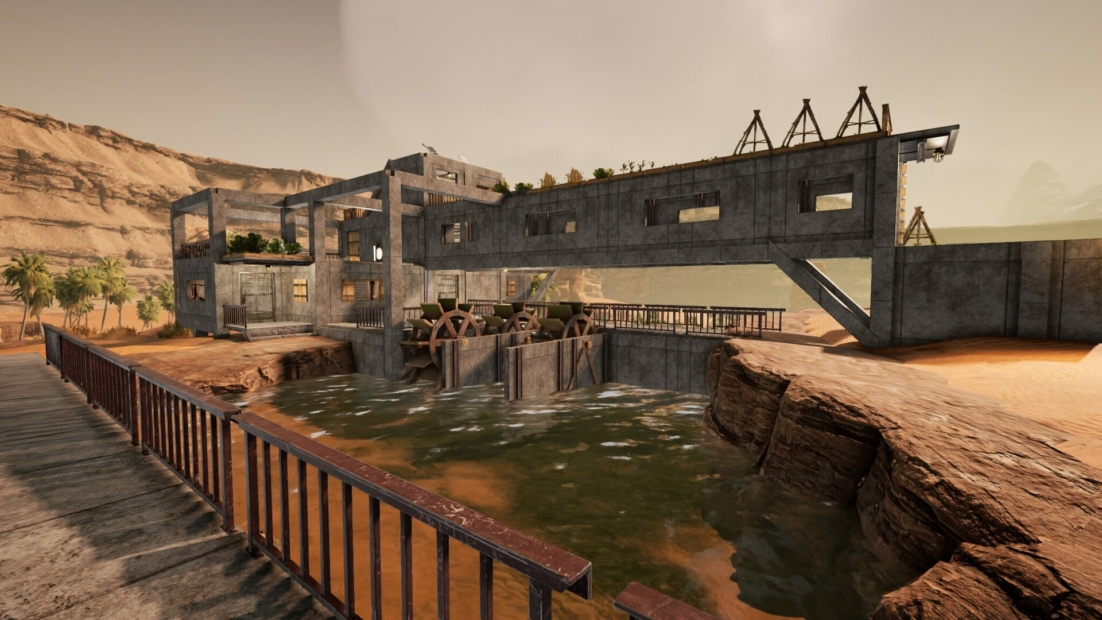 Betongebäude mit Wasserrad über einem Wasserbecken in einer wüstenartigen Landschaft mit Felsen und Palmen