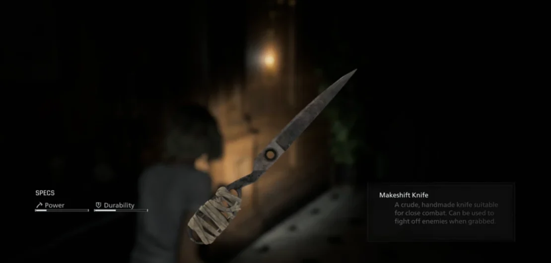 Close-up of a makeshift knife with a wrapped handle against a blurred dark alley background