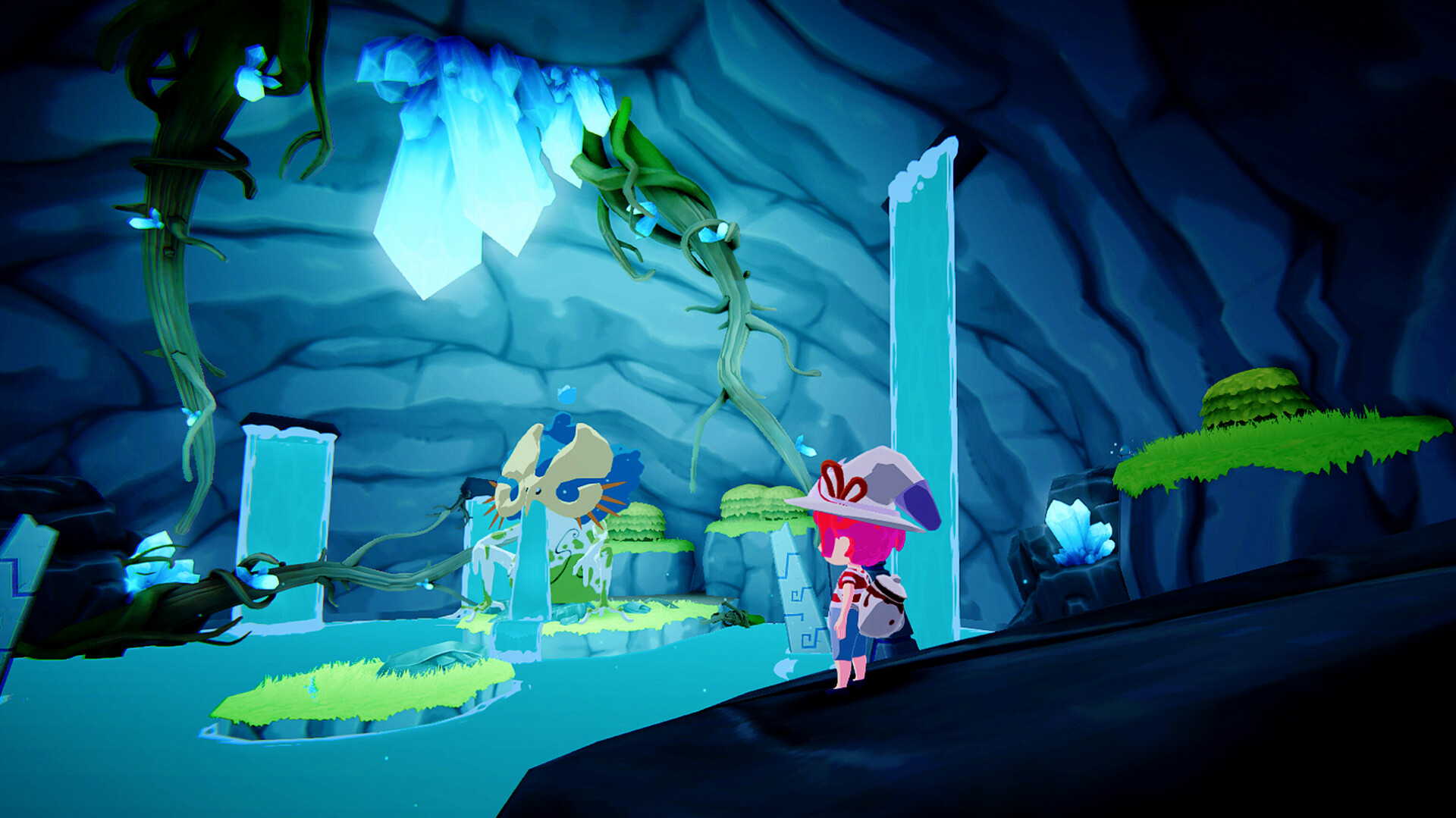 Mika, eine Figur mit pinken Haaren und einem lila Hut, steht in einer leuchtenden Höhle mit Kristallformationen und grünen Moosplattformen im Spiel „Mika the Witch's Mountain“.