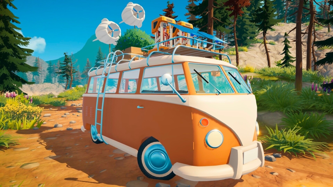 Orange and white camper van with roof rack and two large speakers on a forest path