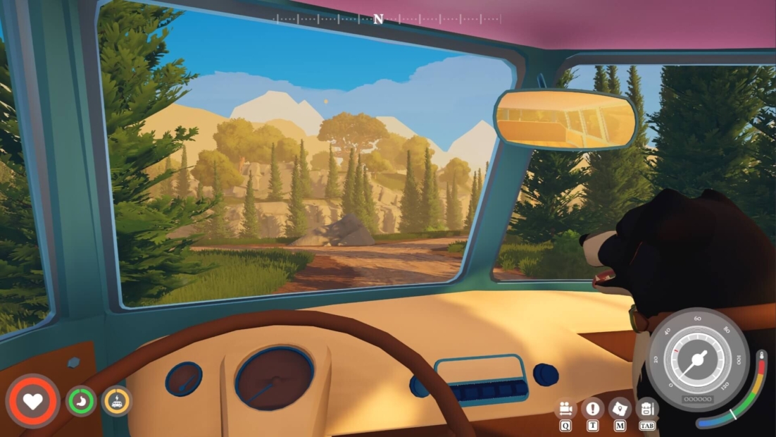 View from inside a vehicle showing a forested landscape with mountains in the background and an arm extending out the window
