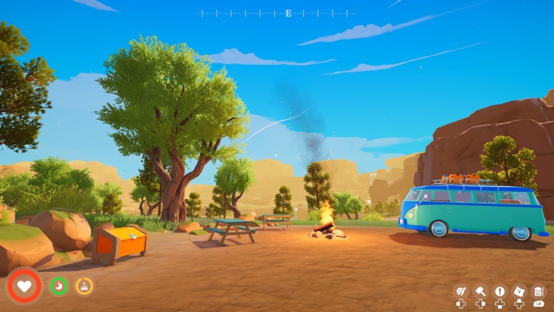 Campsite with campfire, blue van with luggage on roof, picnic table, and trees in a desert-like landscape