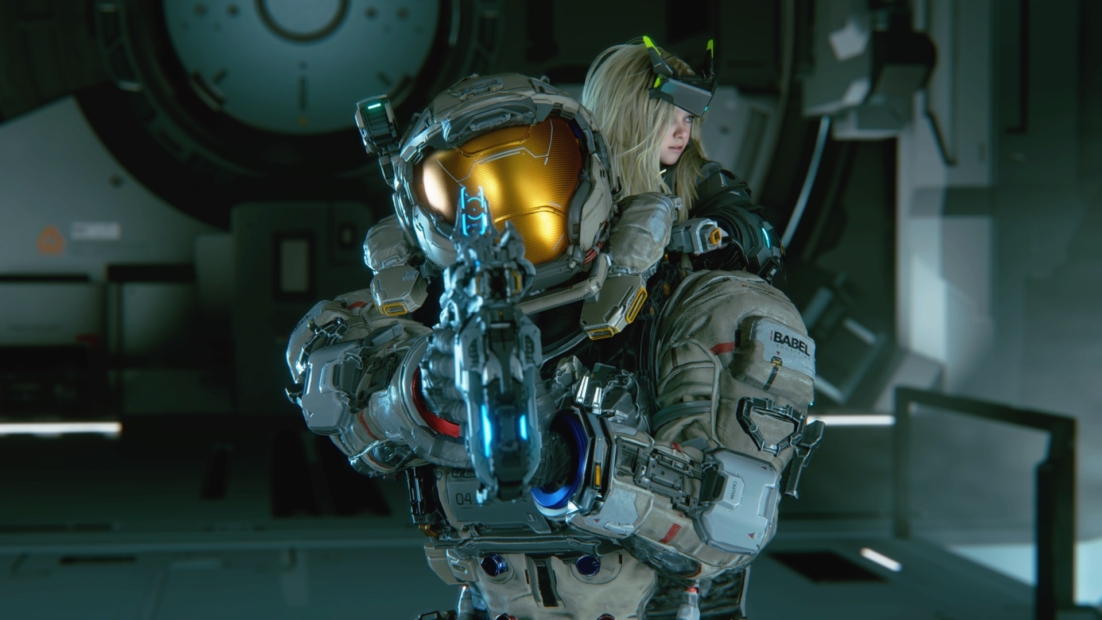 Person in futuristic armor with helmet and visor holding a weapon in a dark, technical room