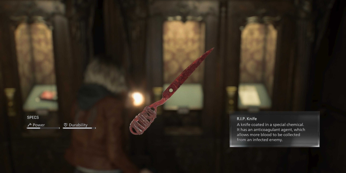 Close-up of a knife with a serrated blade and grooved handle against a blurred background with two illuminated signs.