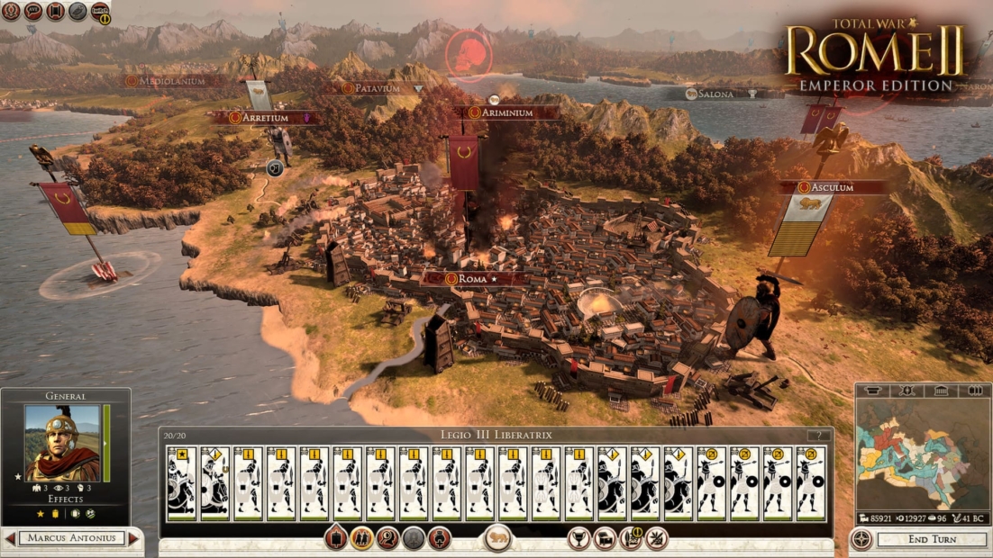 Screenshot from Total War: Rome II Emperor Edition showing a detailed city view of Rome surrounded by landscape and water, with unit cards and game interface below.