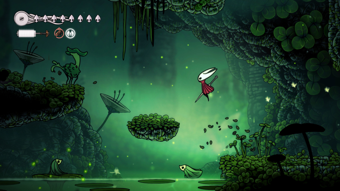 A character with a white head and red cloak jumps over a floating platform in a green, lush environment. Plants and glowing points are visible in the background.
