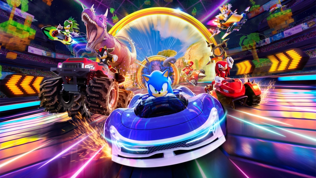 Sonic and other characters race in futuristic vehicles on a colorful track with a large dinosaur in the background.