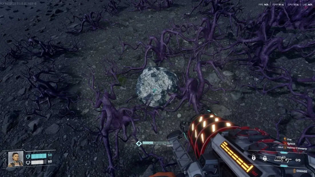 View of a rugged, earthy surface with purple root-like structures and a glowing spherical object in the center, seen from a first-person perspective holding a futuristic device.