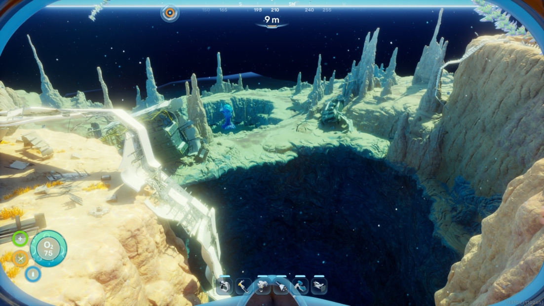 Underwater landscape with rocks, a large dark cave, and a diving device in the foreground
