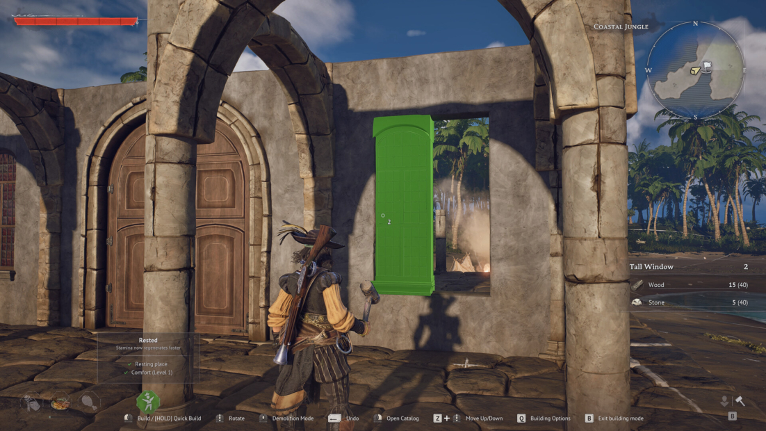 Game character stands in front of a partially ruined stone building with arches and a green door in a jungle setting